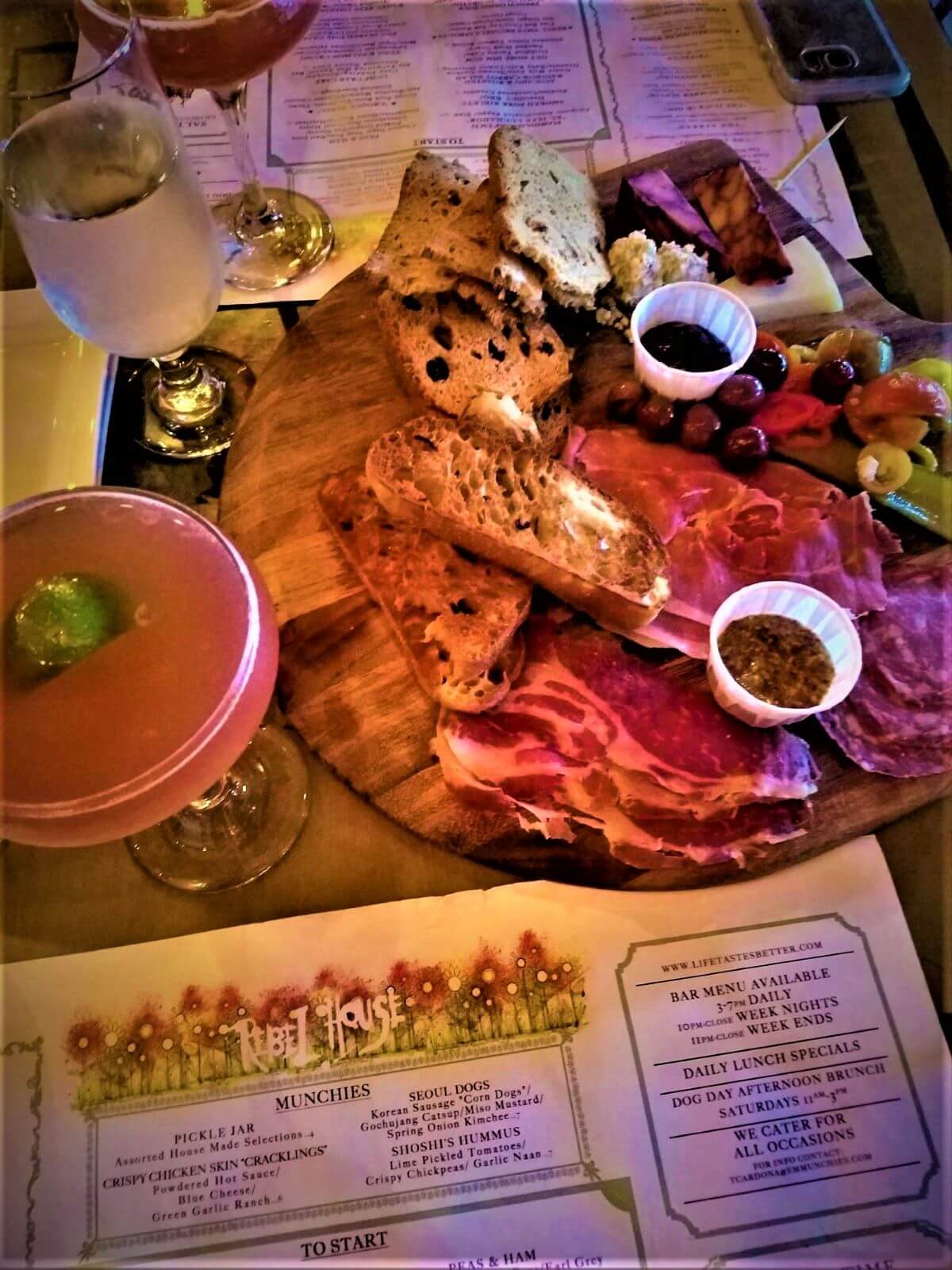 alt text = "a fancy cocktail with charcuterie board of meats, cheeses and accompaniments"