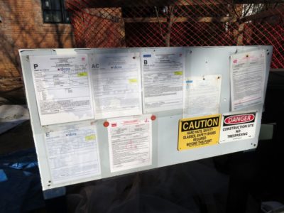 alt="Building code violations posted on a bulletin board to depict seller's obligation to disclose building code violations"