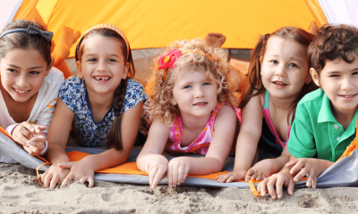 Kids having fun at the beach under shade tent