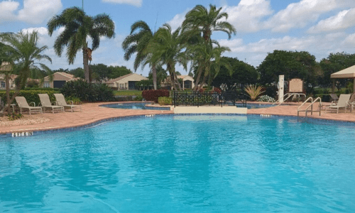 alt="Valencia Falls resort style community pool overlooking a lake"