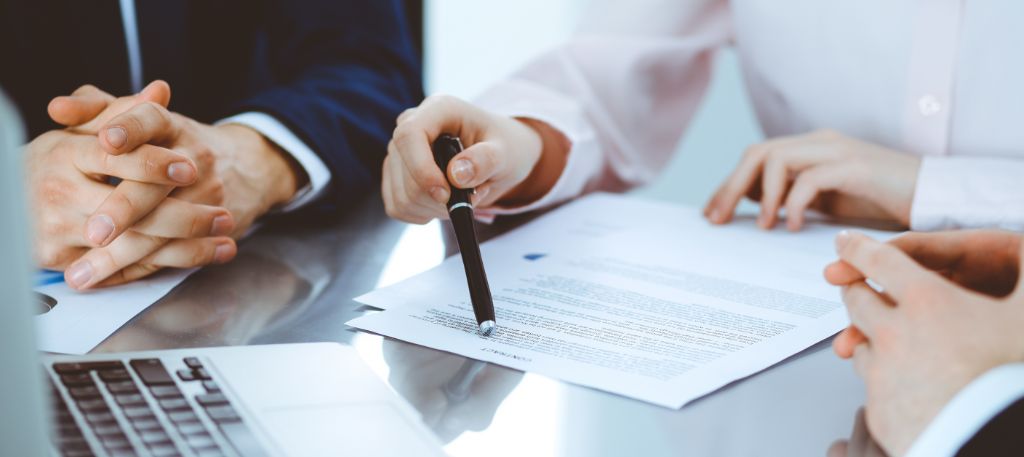 Real estate contract with contingency clauses reviewed by a homebuyer and real estate agent